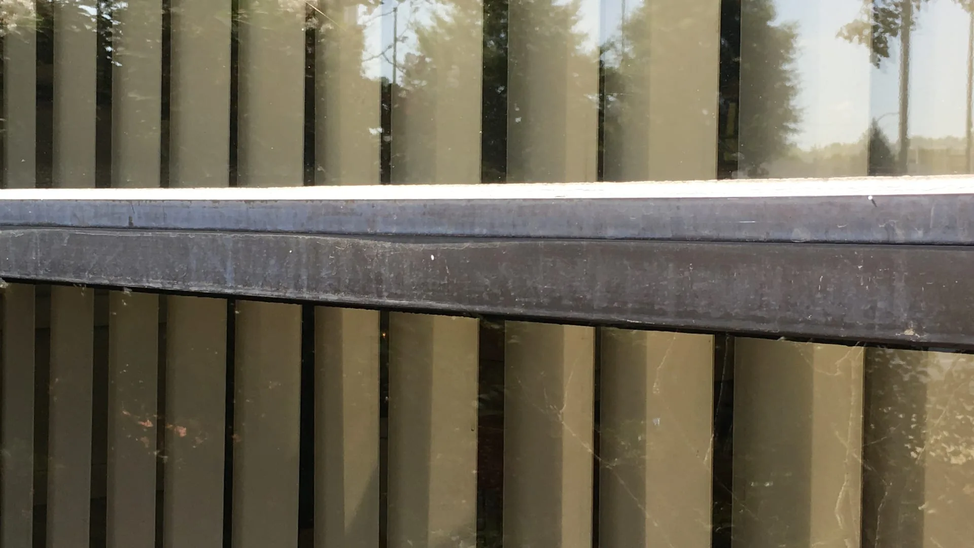 Exterior window metal joint that needs to be refinished and cleaned from weather deposits