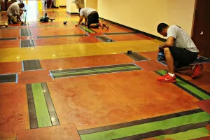 Mid America Specialty Services staff staining concrete flooring in a commercial building