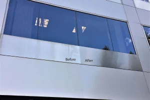 Before and after cleaning comparison of exterior metal paneling around office windows