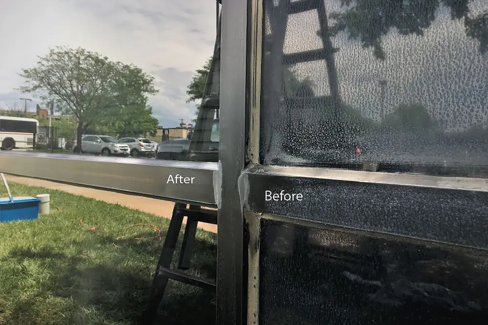 Close up before and after comparison of oxidation being removed from dark metal window frames