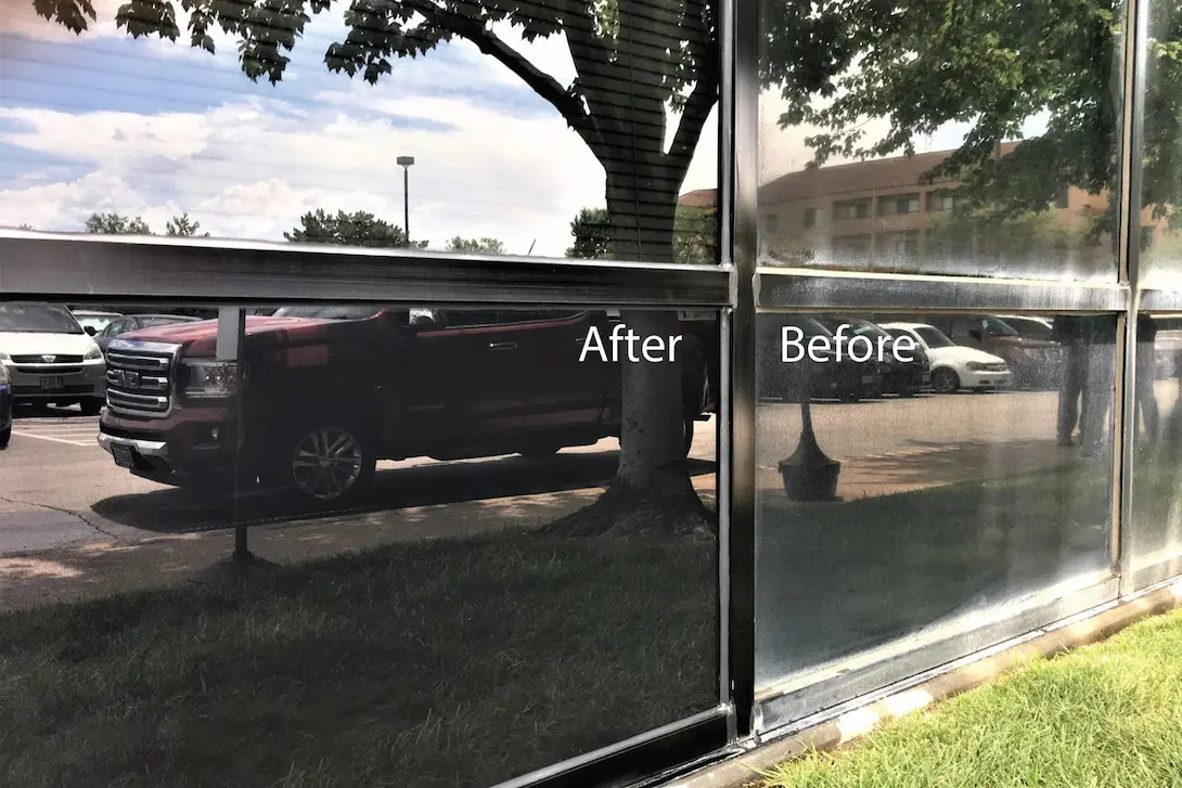 Before and after comparison of oxidation being removed from dark metal window frames