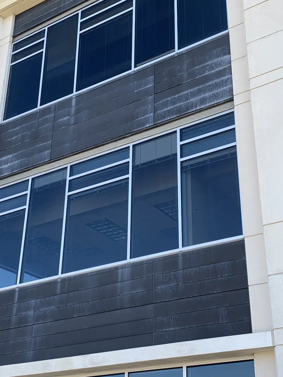 Commercial glass and brick facade in need of refinishing