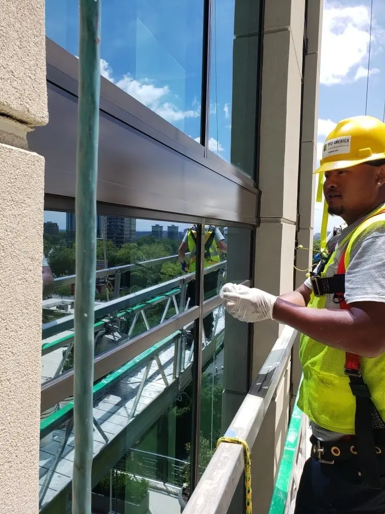 Technician refinishing exterior glass