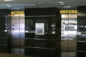 Mirrored to satin finish comparison of metal elevator doors in an office building