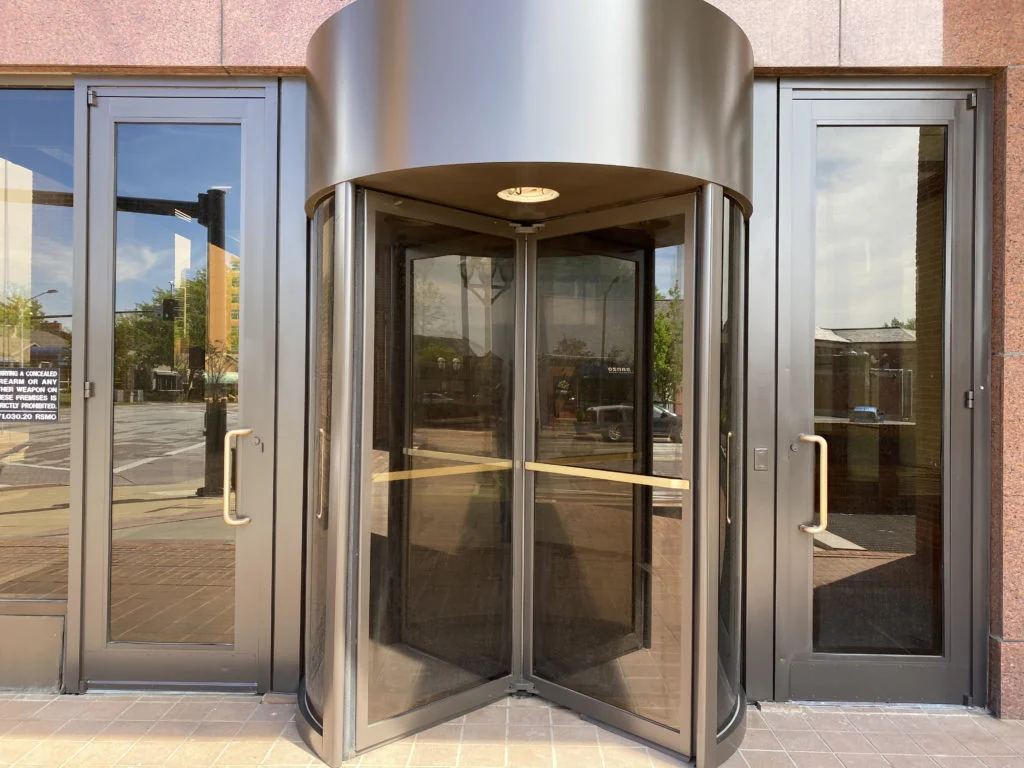 Image of revolving exterior door that has been refinished with Kynar-based paint