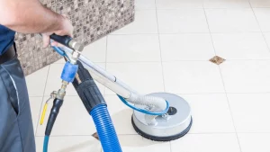 Mid America employee using rotary cleaning tool for stone floor maintenance