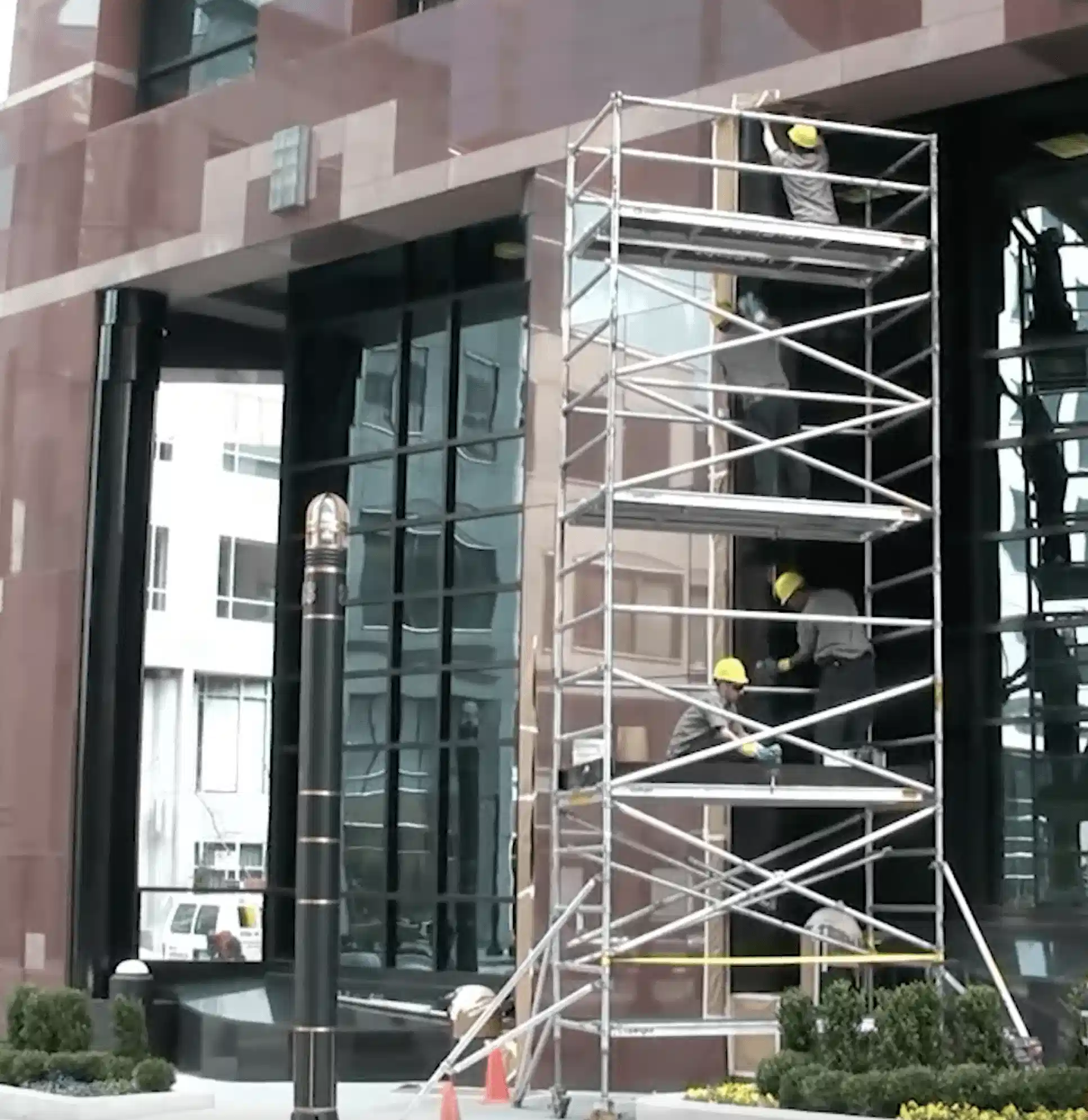 Technicians on scaffolding restoring a building facade