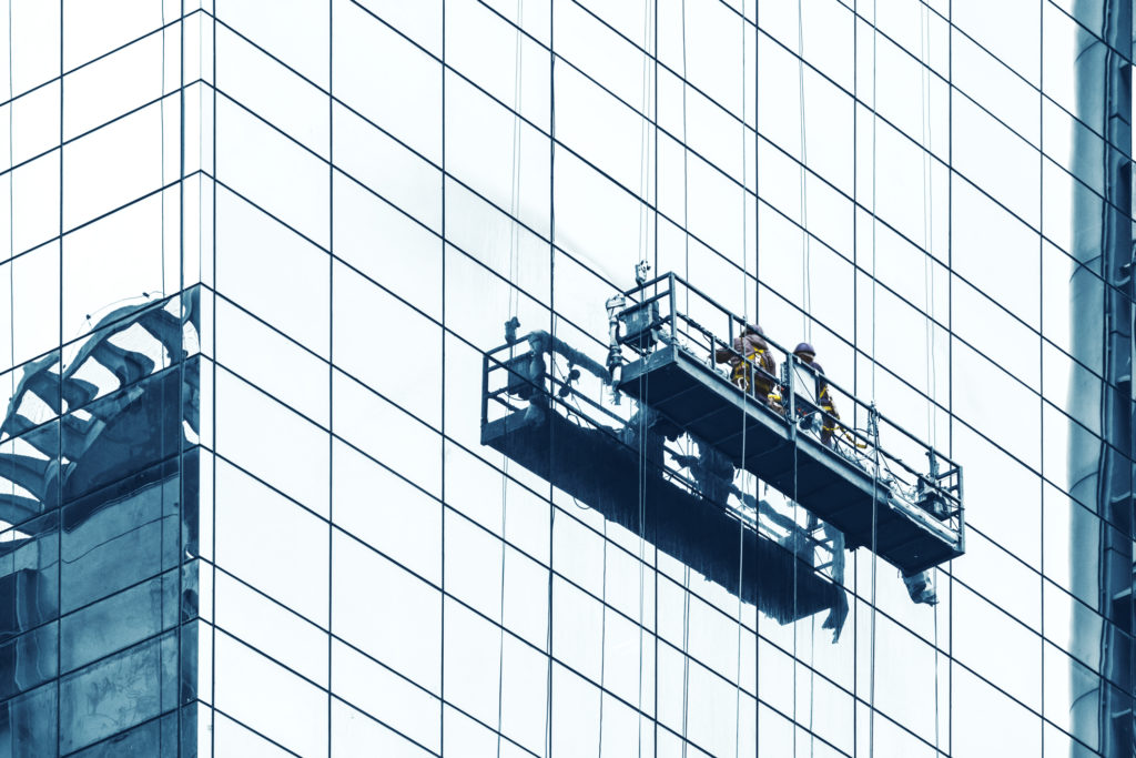 commercial window cleaning being performed on skyscraper